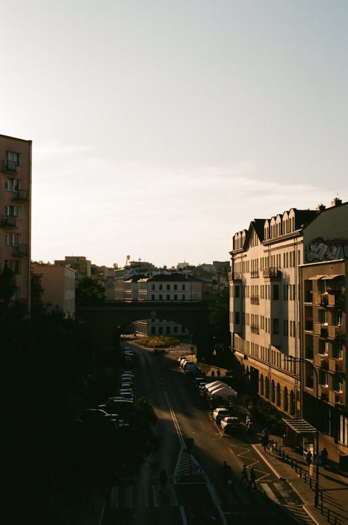 Captivating view of a Warsaw city street with sunset light and urban architecture.